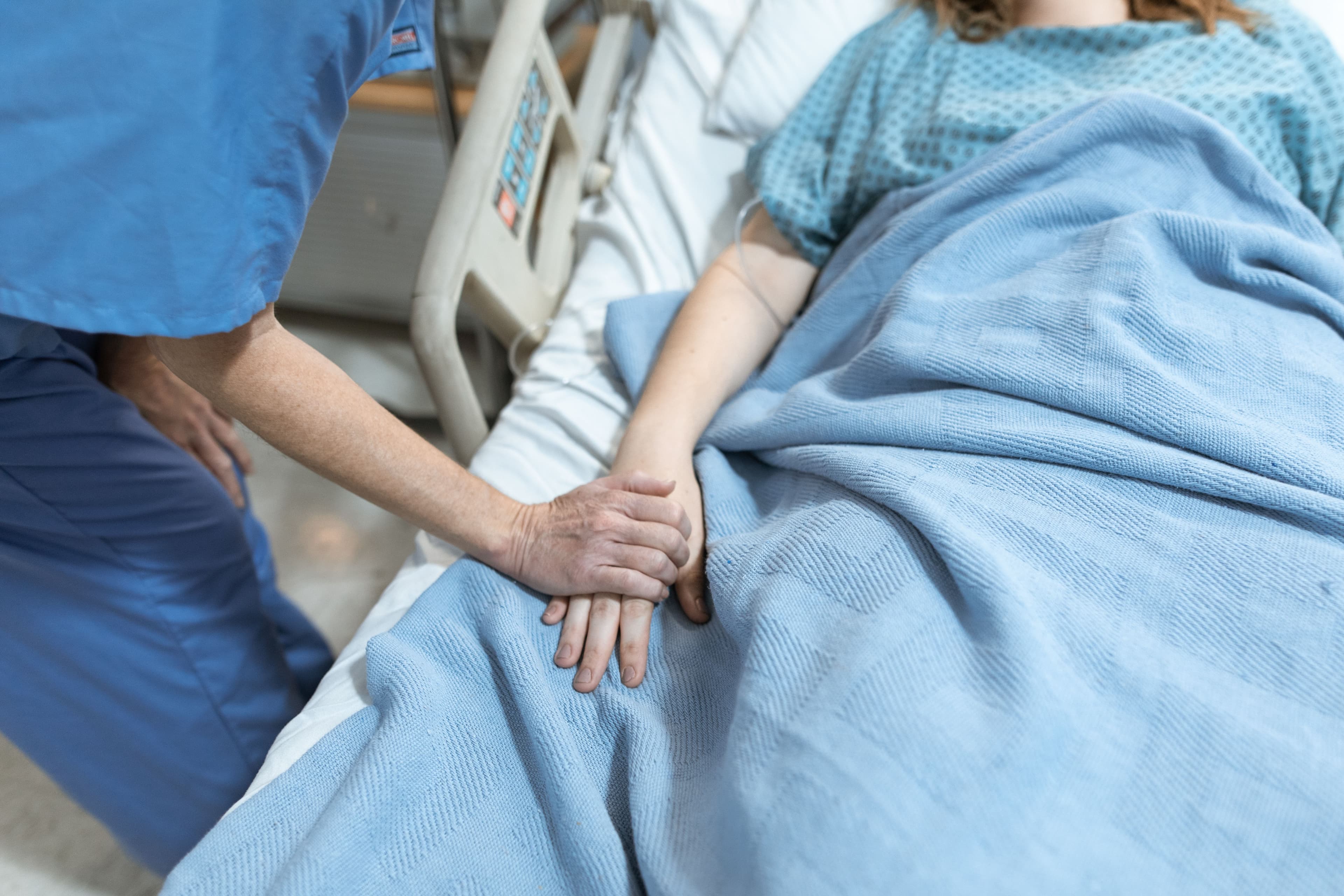 A nurse checking in warmly with a patient