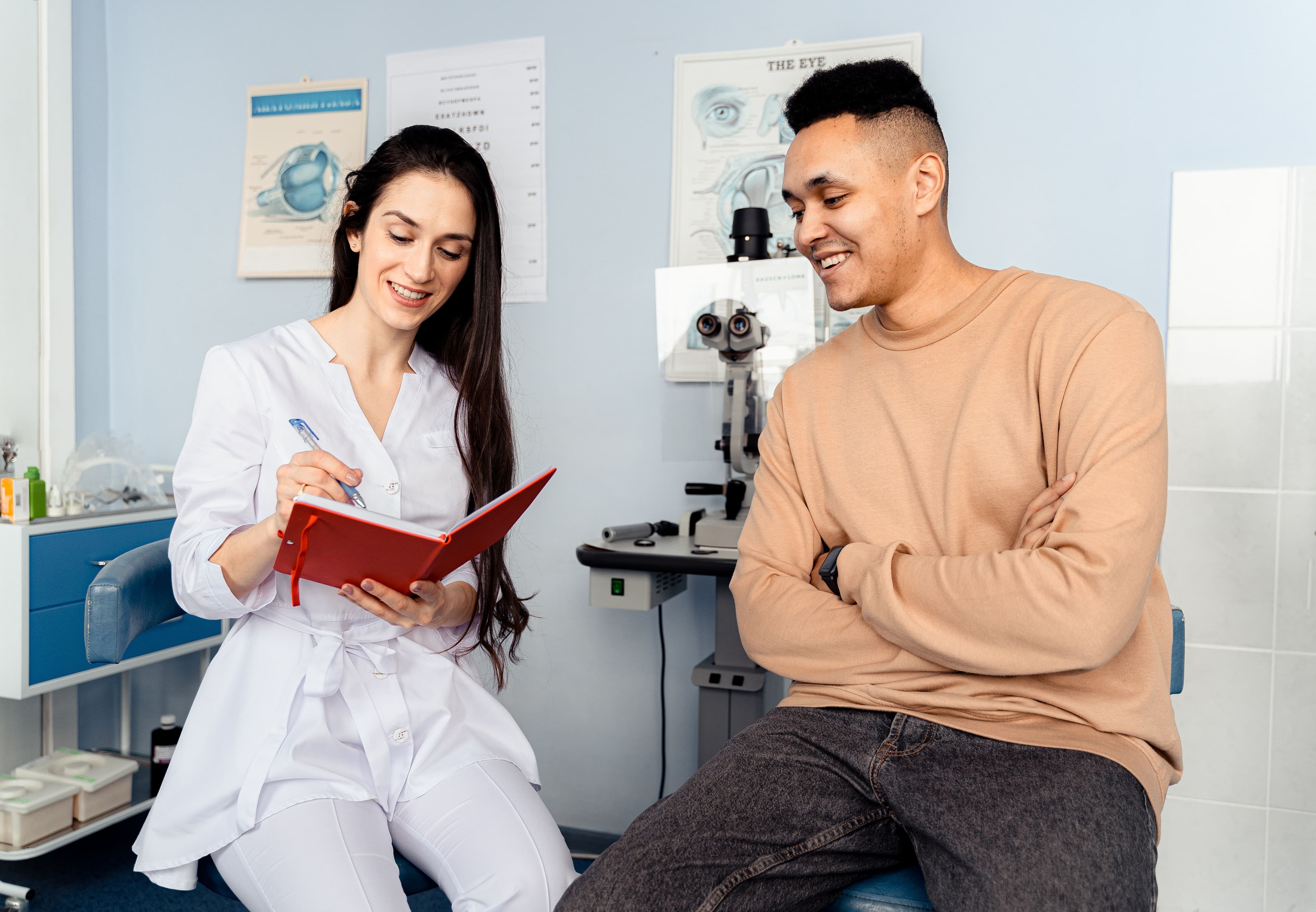 A physician reviewing care notes with a smiling patient